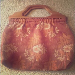 Wooden handled cloth purse.